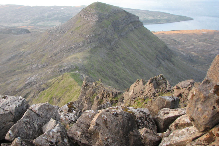 view of dramatic hilly scottish landscape, sea in background