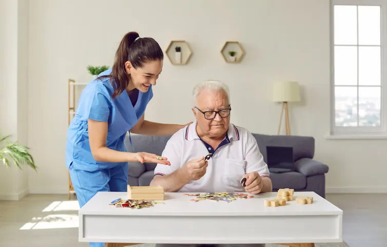 An elderly man and his carer
