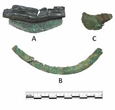 three curved greenish metal blades