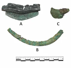three curved greenish metal blades