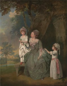 A woman and her two children painted wearing stays.