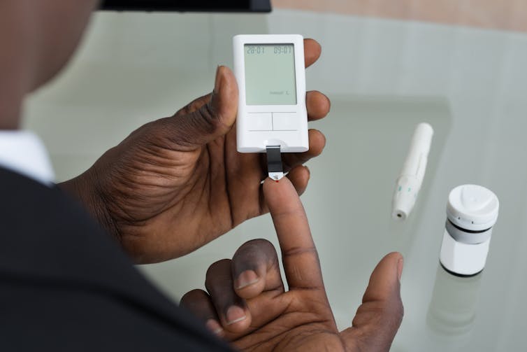 Close-up view of a person using a blood-sugar monitor