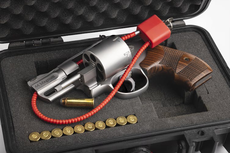 A revolver with a red cable key lock.