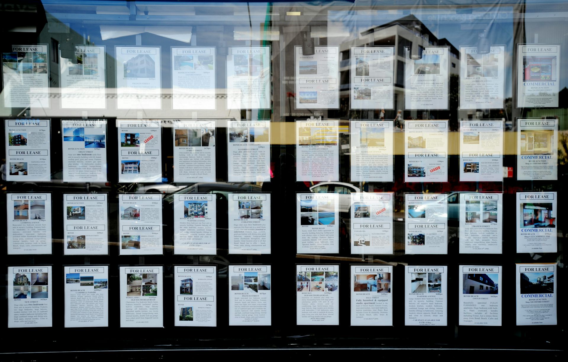 Houses advertised for sale in a real estate agent's windown