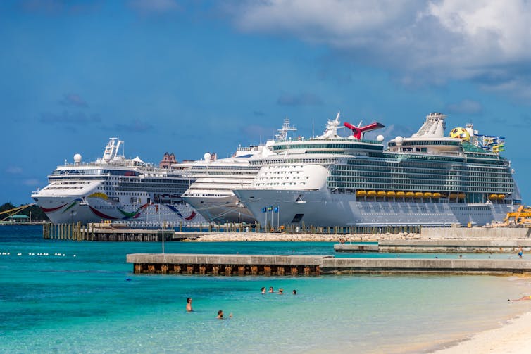 Three different cruise ships docked near a beach in Nassau in the Bahamas