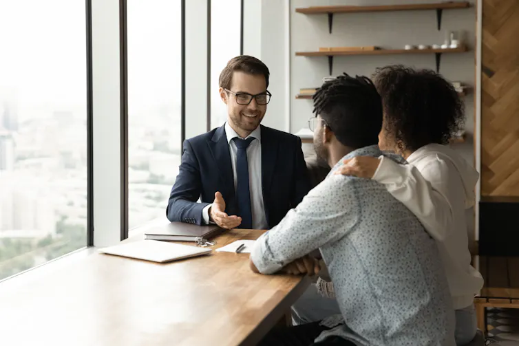 A couple talks with a real estate agent