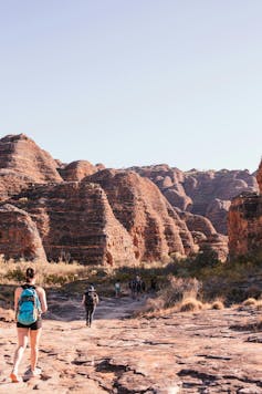 Tourists walk along a track toward the Bungle Bungles in the Kimberley