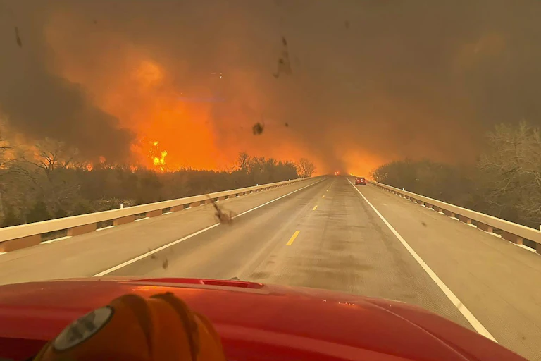 Looking down a road towards a huge fire