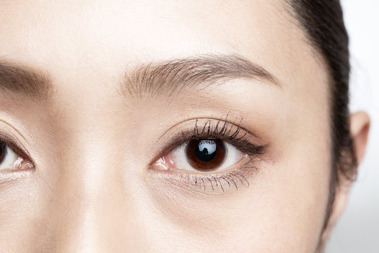 A close-up of a young woman's eye.