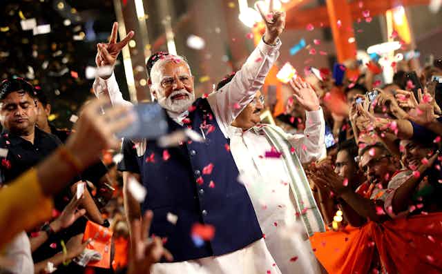 Narendra Modri celebrates with supporters.