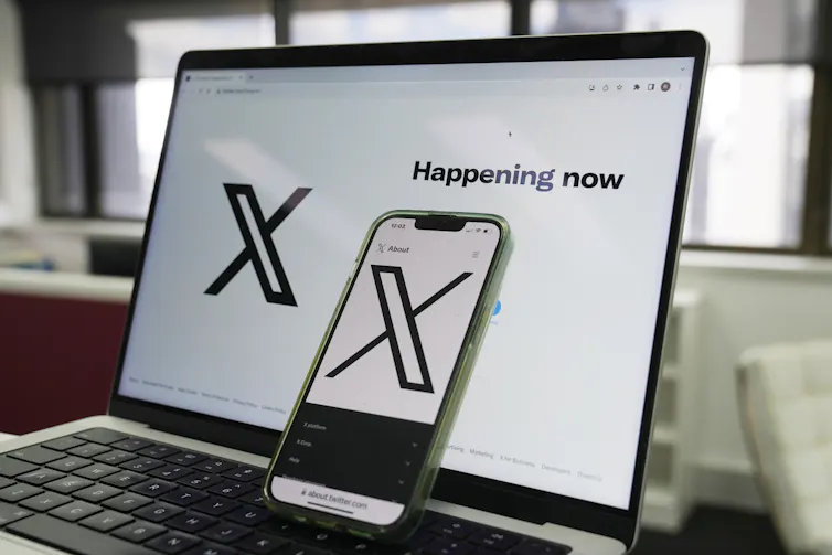 A laptop screen showing the X website behind a smartphone screen showing the same website.