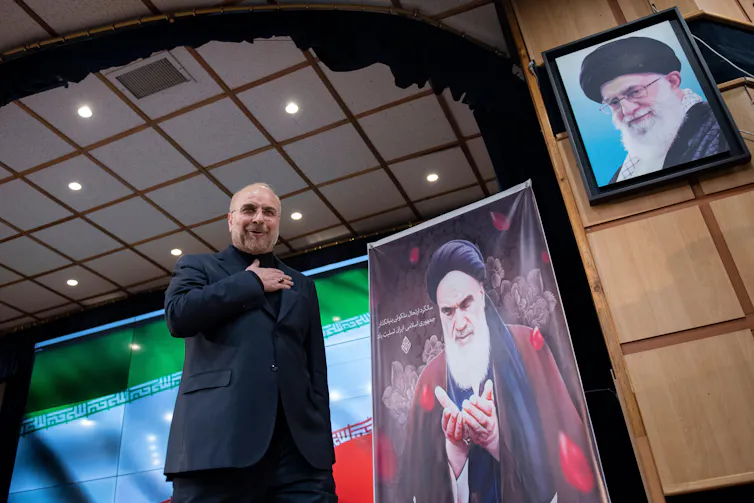 Iranian parliamentary speaker and presidential candidate Mohammad Bagher Ghalibaf waves for the press after registering for the eleciton.