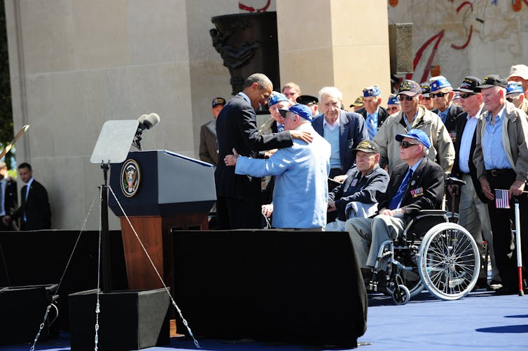 People on a stage with the US president, Barack Obama.