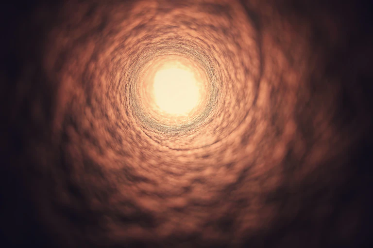 Flesh-colored, textured tunnel funnelling to a circle of light