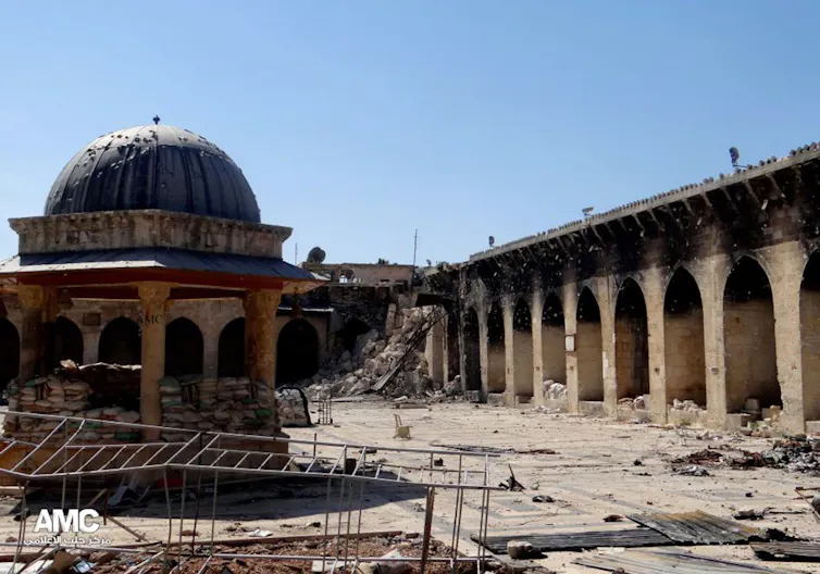 This journalism image provided by Aleppo Media Center AMC which has been authenticated based on its contents and other AP reporting, shows the damaged famed 12th century Umayyad mosque without the minaret, background right corner, which was destroyed by the shelling, in the northern city of Aleppo, Syria, Wednesday April 24, 2013