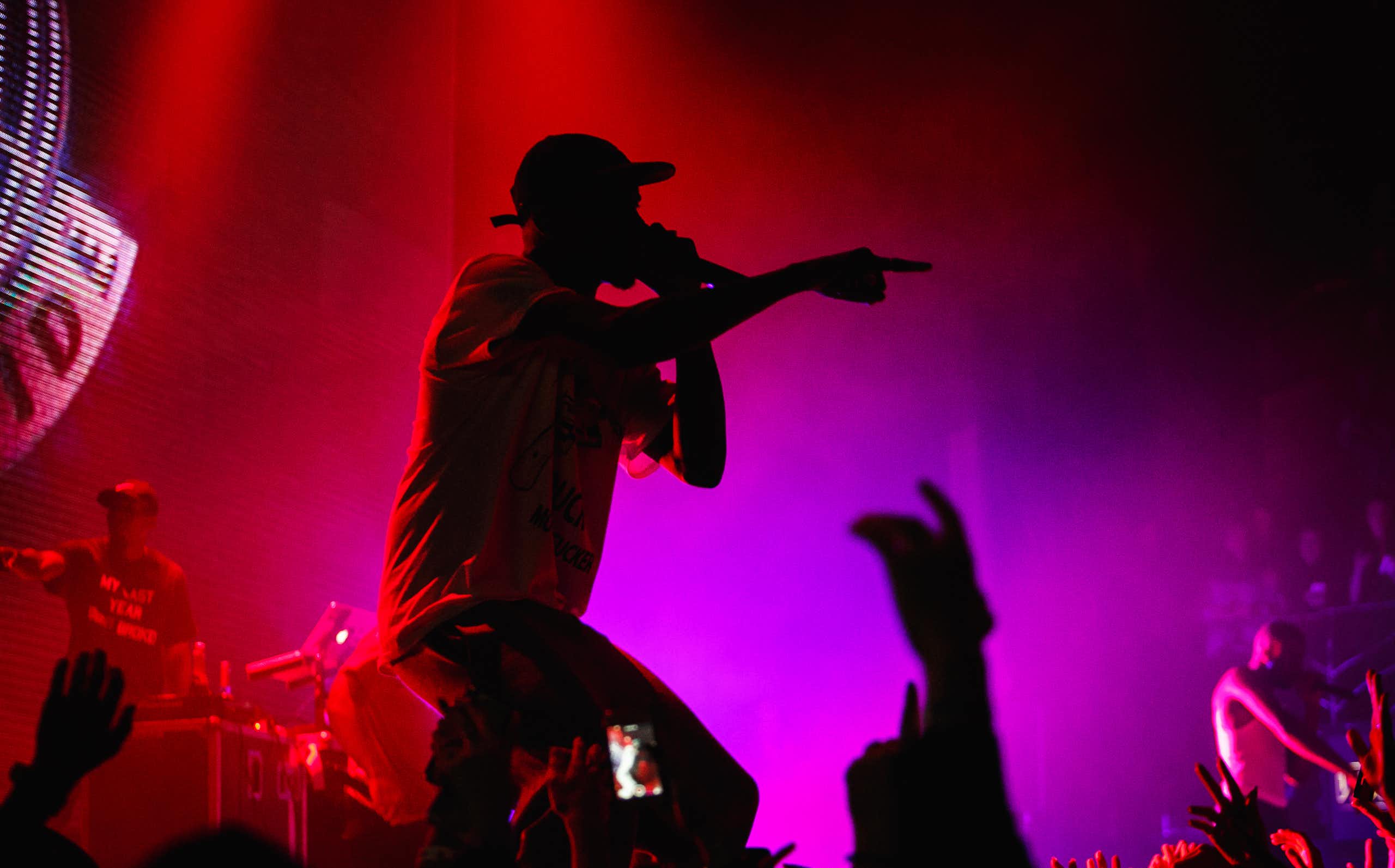 Silhouetted rapper performs to crowd