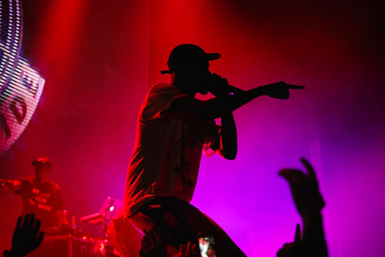 Silhouetted rapper performs to crowd