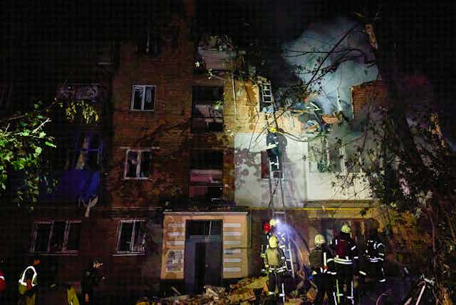 Firefighters battle a blaze on a house in Kharkiv, northern Ukraine.