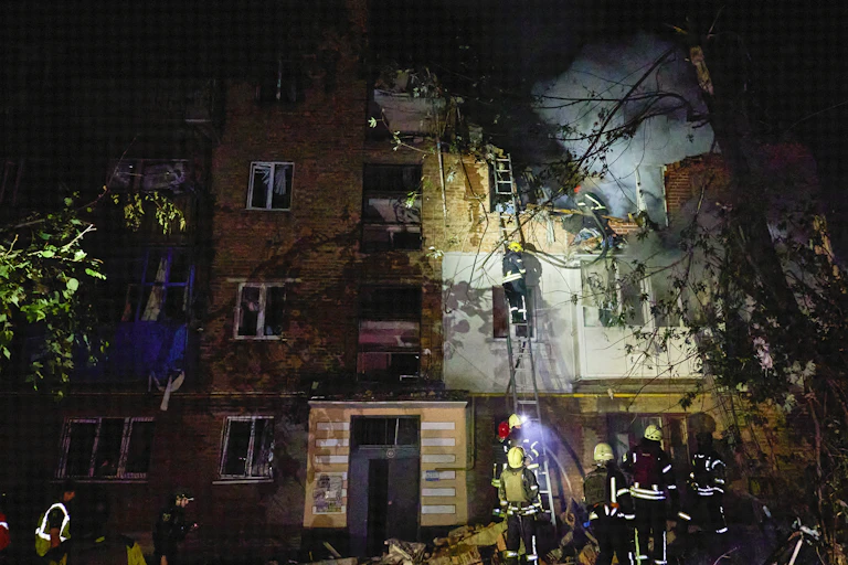 Firefighters battle a blaze on a house in Kharkiv, northern Ukraine.