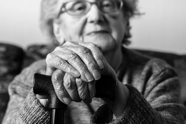 A black and white photograph of an elderly lady.