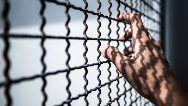 A hand resting on mental bars