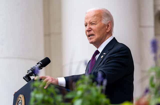 Joe Biden standing at a podium giving a speech.