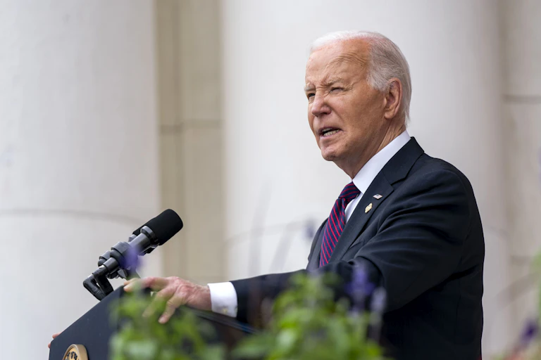 Joe Biden standing at a podium giving a speech.