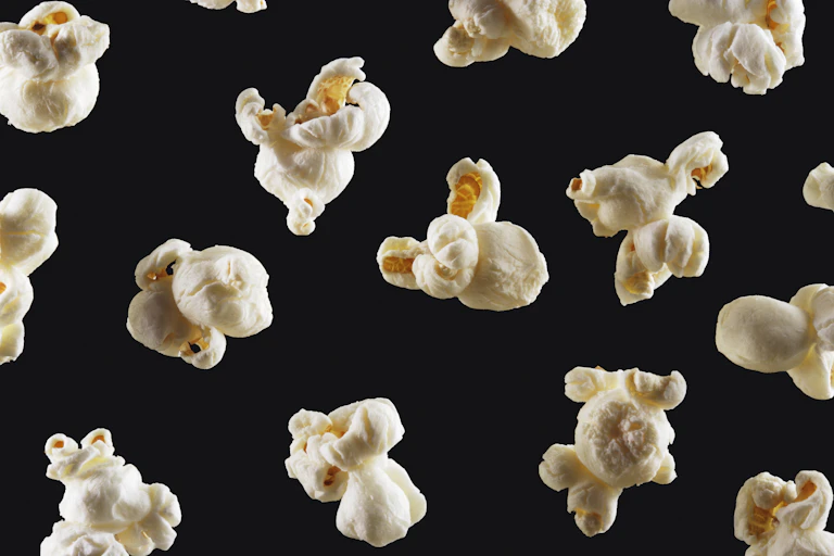 popped kernels against a black background