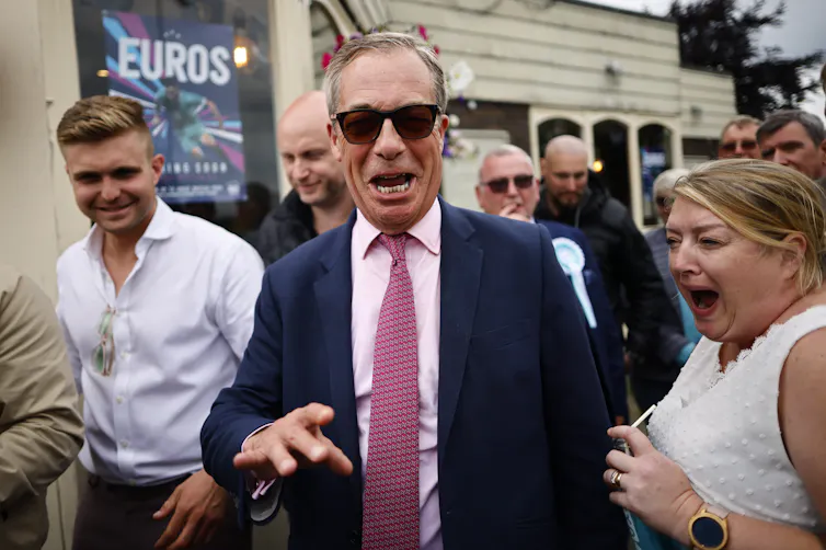 Nigel Farage laughing with a member of the public.