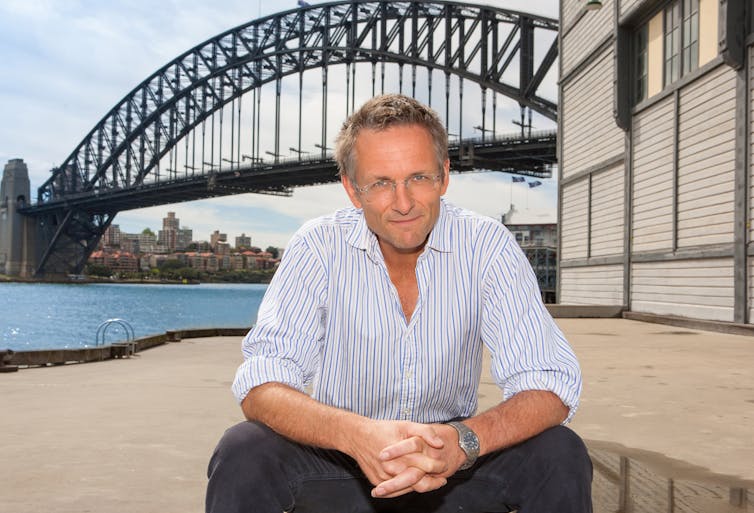 Michael Mosley sitting in front of the Sydney Harbor Bridge in 2013.