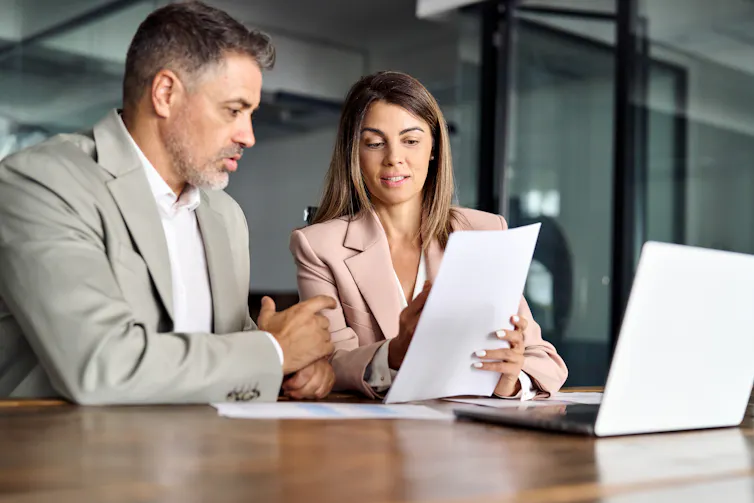 Woman explaining a document to a man