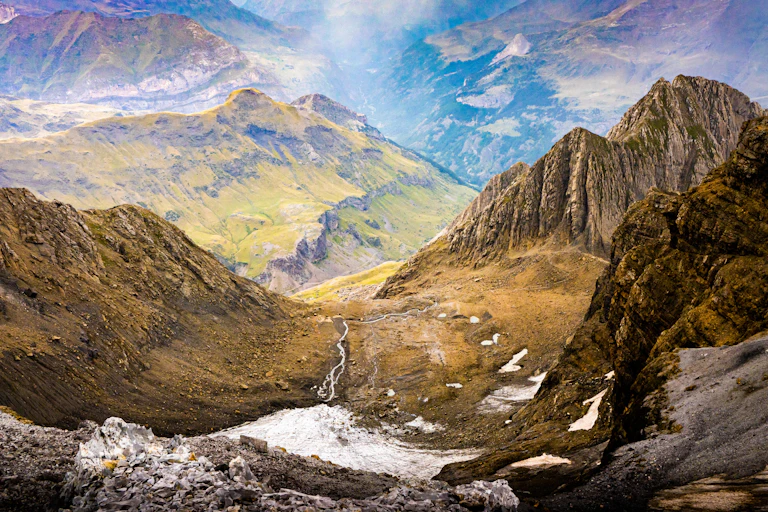 Dramatic green mountain scenery with a low balley running through the middle