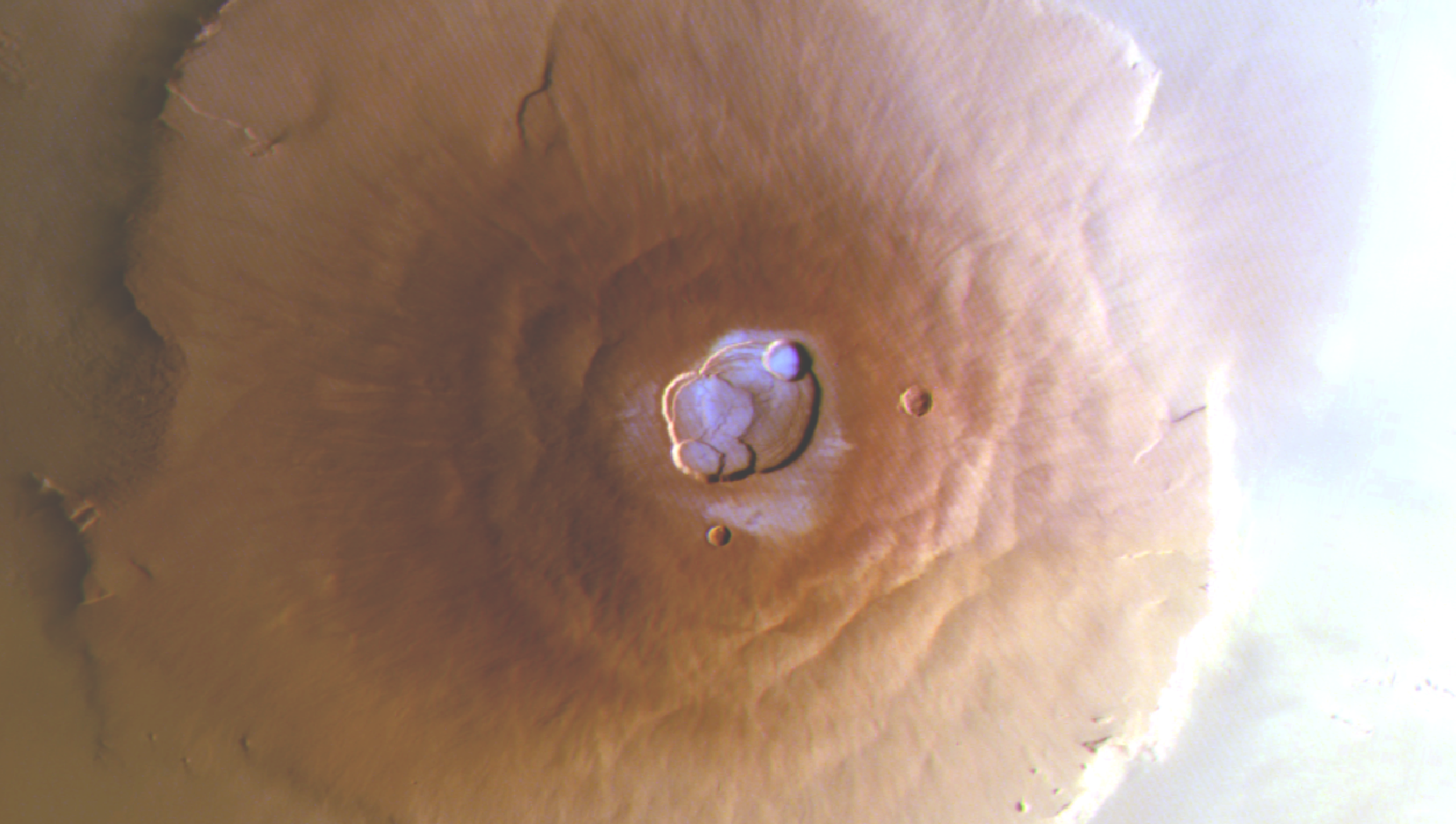 The summit of Olympus Mons on Mars, with frozen water visible in the crater.