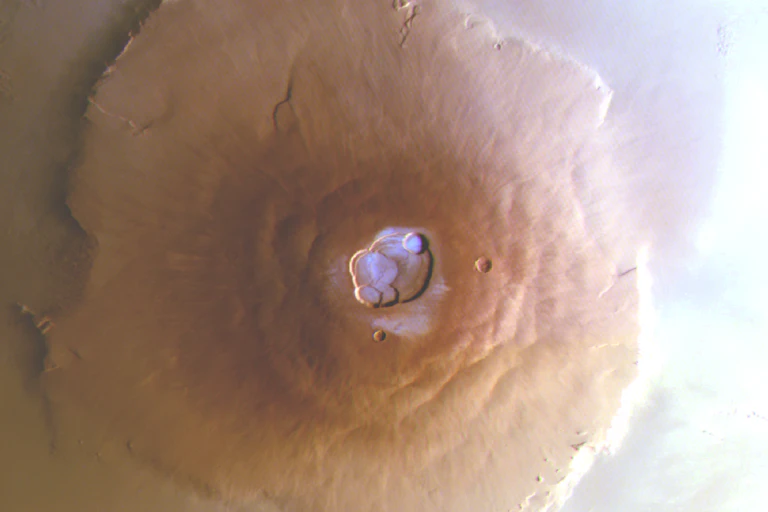 The summit of Olympus Mons on Mars, with frozen water visible in the crater.