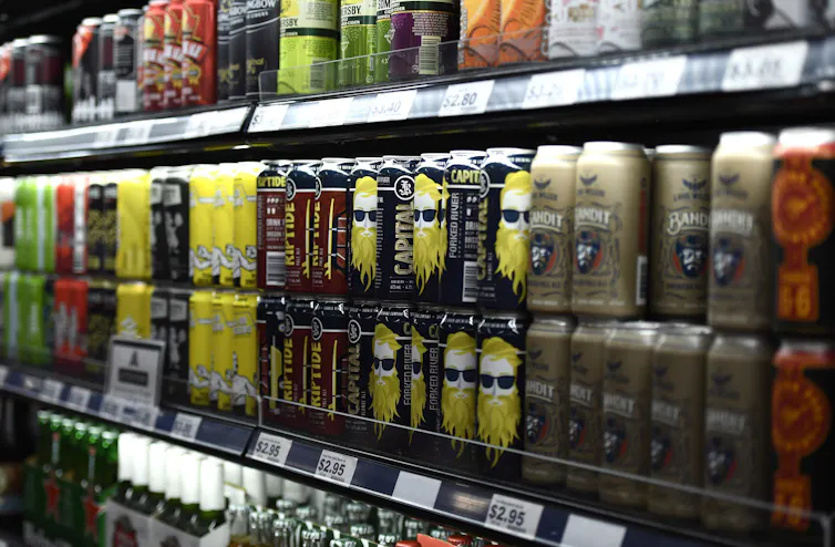 A shelf of beer and other canned alcoholic beverages
