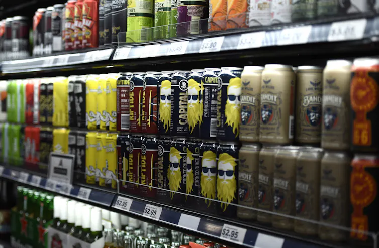 A shelf of beer and other canned alcoholic beverages
