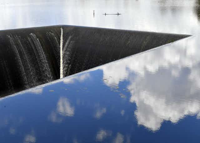 water reflects clouds with one section draining water downwards