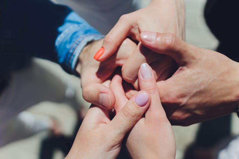 A group of people holding hands.