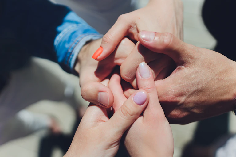 A group of people holding hands.