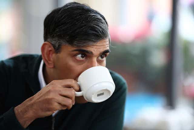 Rishi Sunak drinking from a teacup.