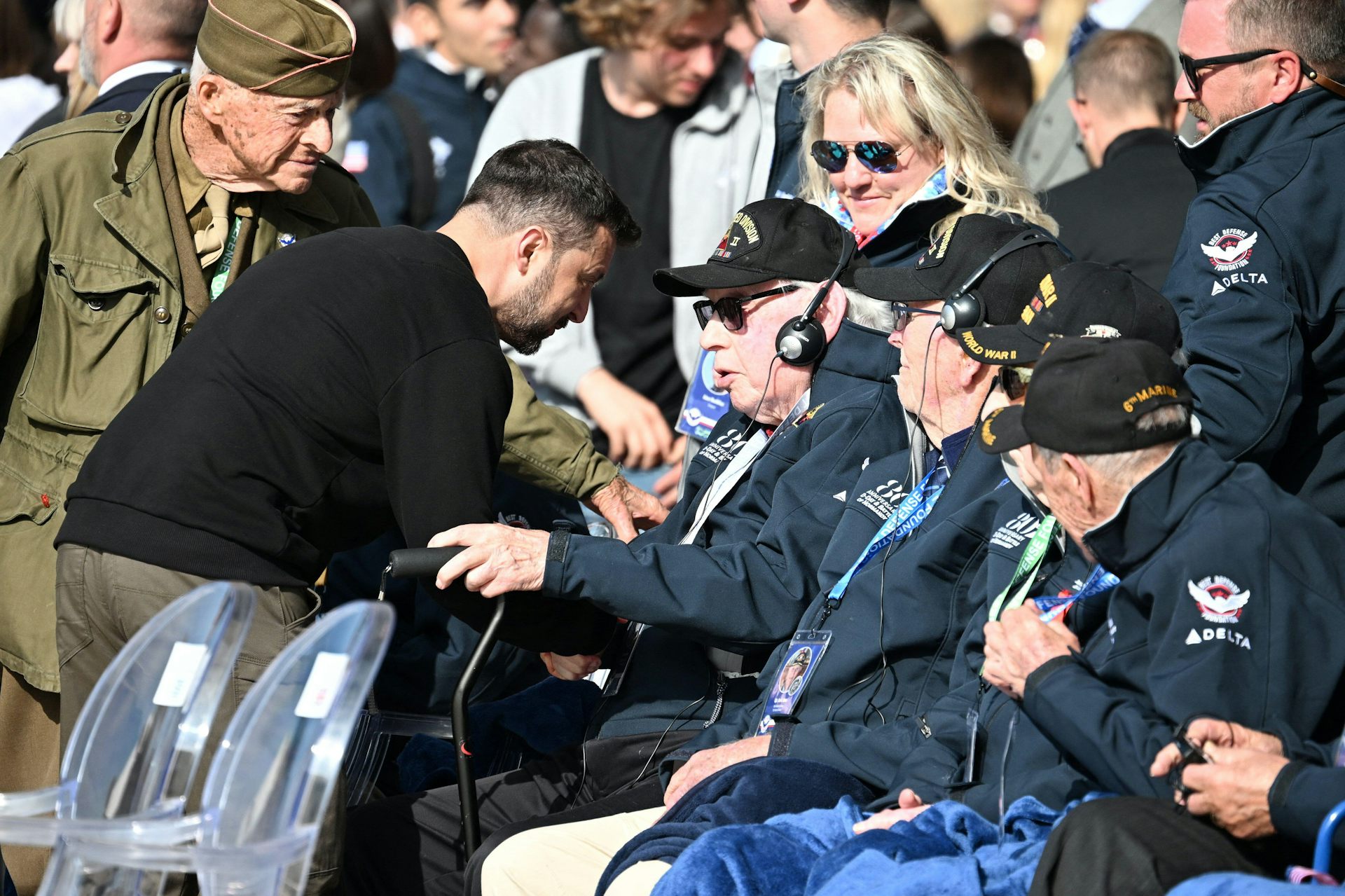 Ukrainian president, Volodymyr Zelensky, greets a D-day veteran at Omaha Beach, June 6 2024.