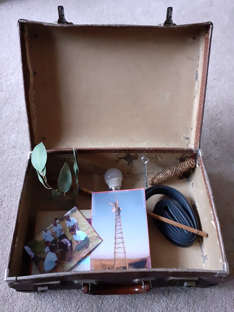 Suitcase with photographs and objects inside