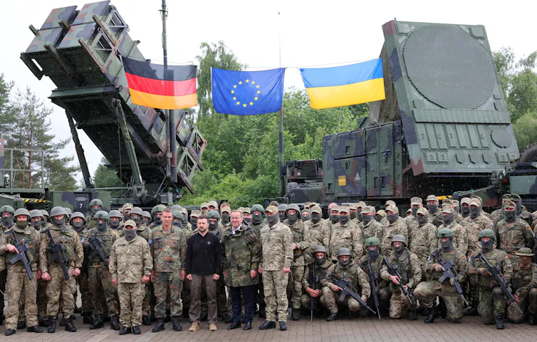 Ukrainian President Volodymyr Zelensky standing with soldiers.