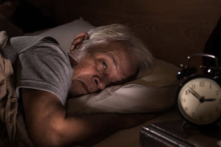 Older man awake with insomnia