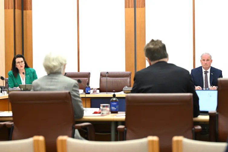 Liberal Senator Richard Colbeck and Labor Senator Deborah O’Neil react to PwC Australia CEO Kevin Burrowes during a public hearing of the Inquiry into management and assurance of integrity by consulting services