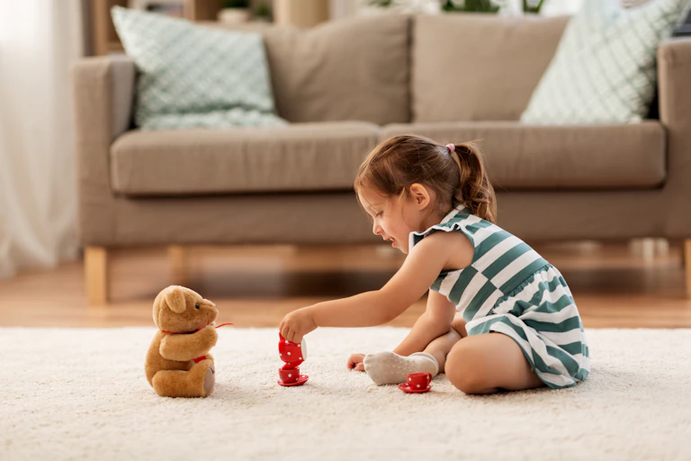 A young girl playing on the floor.