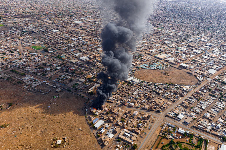 Smoke rises above an urban neighbourhood.