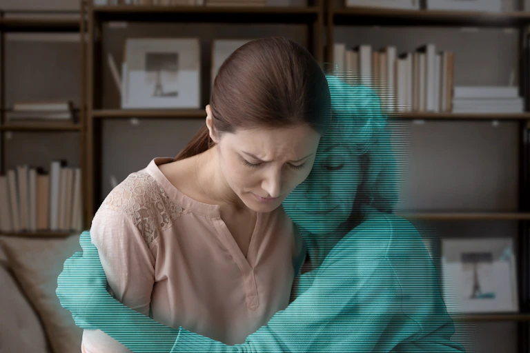 Art concept: a grieving woman is hugged by a blue digital avatar of her mother.