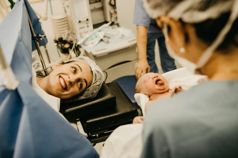 Mother smiles at her new baby