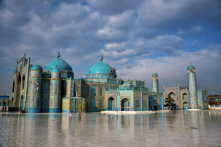 A turquoise shrine on a cloudy day.